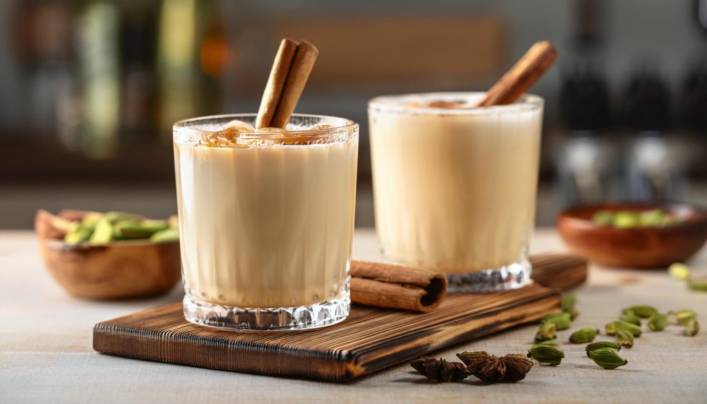 Two Chai White Russian cocktails with cinnamon stick garnish