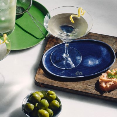 Top view of a classic Martini cocktail served with savory snacks