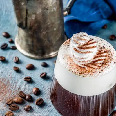 Irish Coffee with cream on blue wooden table