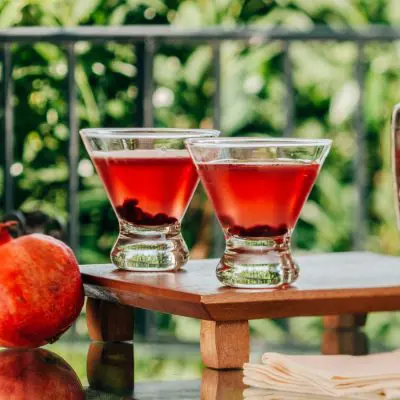 Close up of a pair of Pama Martinis in light bright ourdoor setting on a patio with greenery in the background