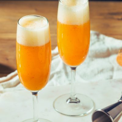 Peach Bellini cocktails served in flute glasses