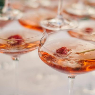 Sparkling Pink Champagne martinis served in coupes and garnished with berries