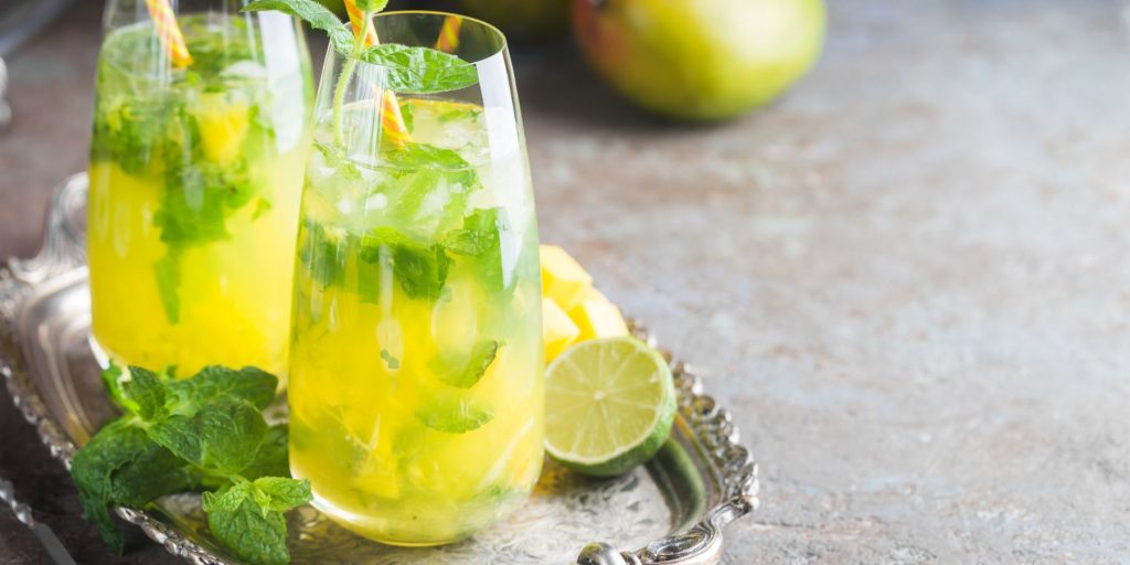 Close up of a pair of enticing French Maid cokctails garnished with mint, served on a silver platter