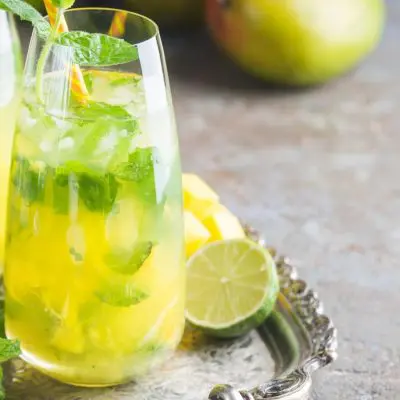 Close up of a pair of enticing French Maid cokctails garnished with mint, served on a silver platter