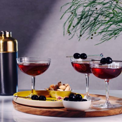 Front view of Manhattan Cocktails garnished with fresh cherries