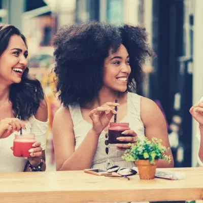 Friends enjoying cocktails at a Parisian street cafe