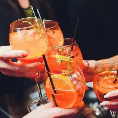 Friends clinking low alcohol cocktails together