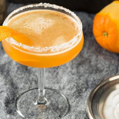 Top view of a Sidecar cocktail garnished with fresh orange peel