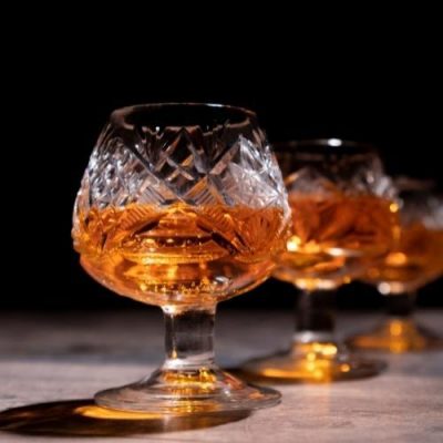 two glasses of cognac in a dark background