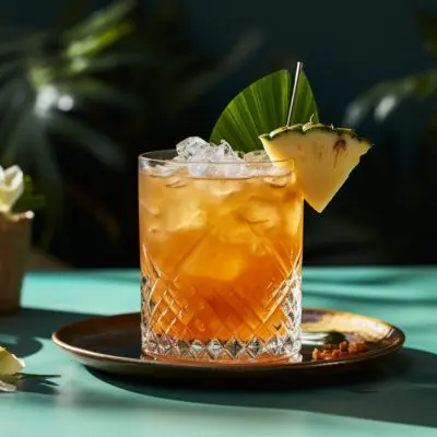 Jungle Bird cocktail with fresh pineapple wedge garnish