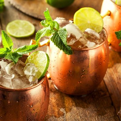 Refreshing Moscow Mule Cocktails in copper mugs with lime and mint garnish