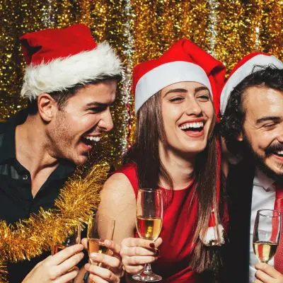 Five friends in Christmas hats celebrating