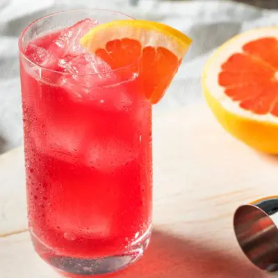 A Sea Breeze cocktail garnished with grapefruit