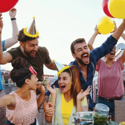 A group of friends in party hats celebrating