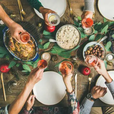 A festive table with a group of friends toasting