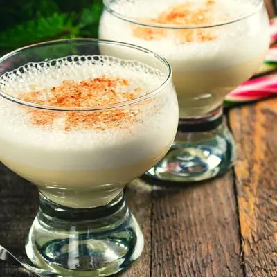 Dairy-free eggnog with candy cane garnish