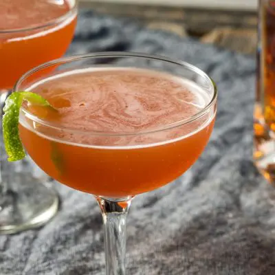 Two cognac cocktails with a twist of lime