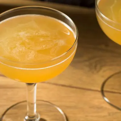 Top view of two Between the Sheets cocktails on a wooden table