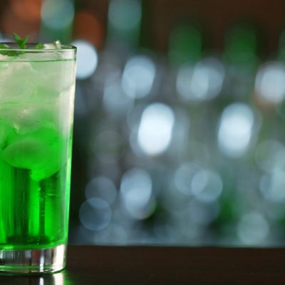 Green Hornet cocktail in a highball glass with ice