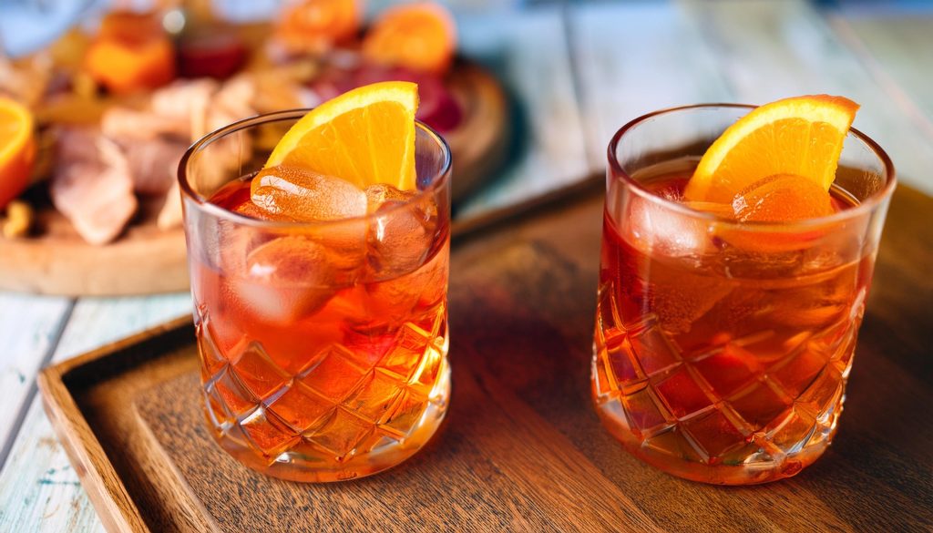 Two Aperol Negroni cocktails with orange garnish