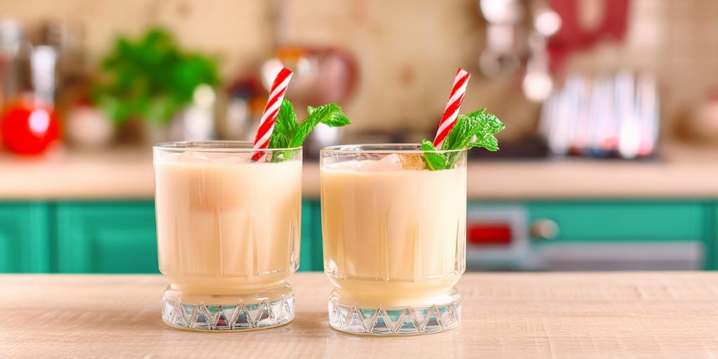 Two Peppermint White Russian mocktails with candy cane and mint garnish