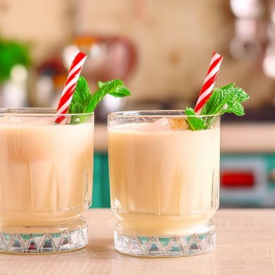 Two Peppermint White Russian mocktails with candy cane and mint garnish