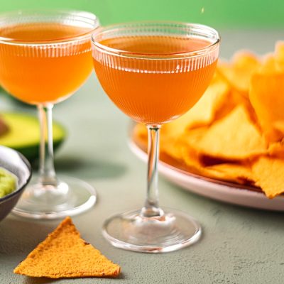 Two Naked and Famous cocktails served with nachos and guacamole