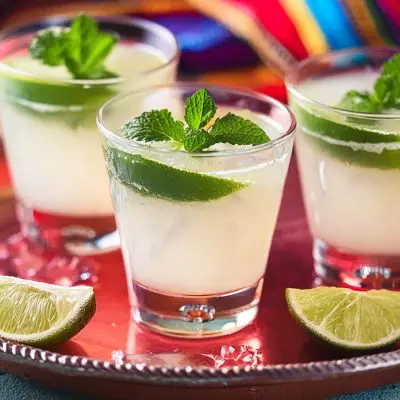 Three Ranch Water cocktails with lime and fresh mint garnish