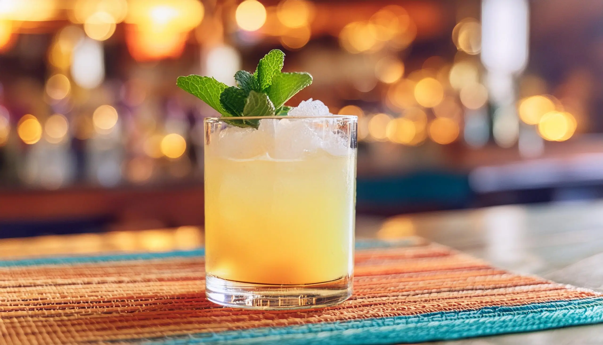 An Añejo Smash cocktail with fresh mint garnish