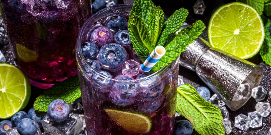 Muddled Blueberry mocktails with fresh mint and lime garnish