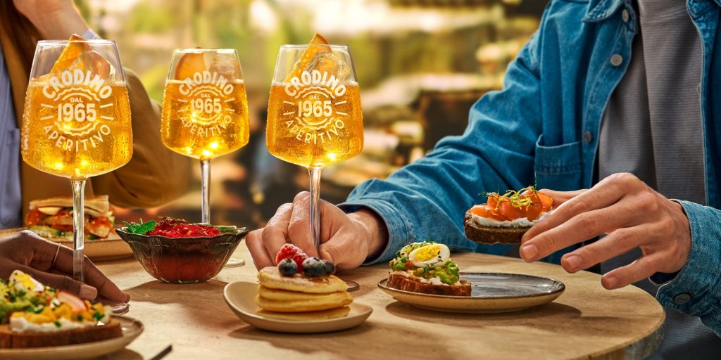 Three glasses of Crodino Non-Alcholic Spritz mocktails served during an aperitivo brunch