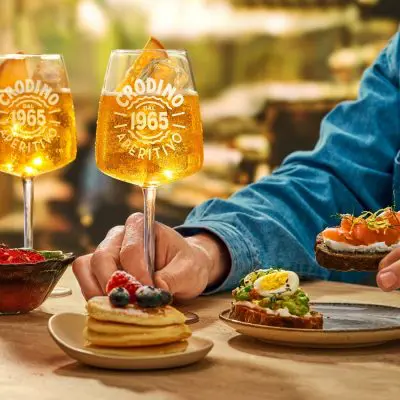 Three glasses of Crodino Non-Alcholic Spritz mocktails served during an aperitivo brunch