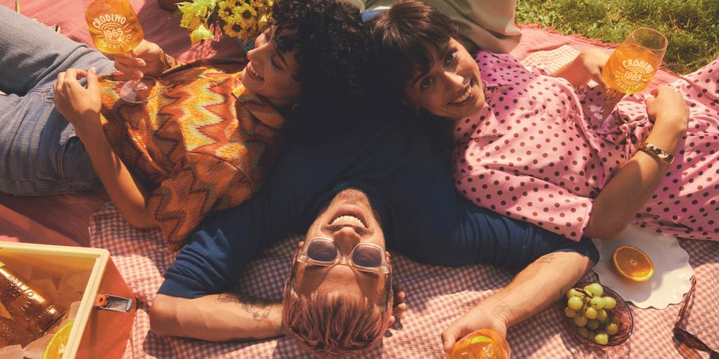 A top view of friends enjoying Crodino Non-Alcoholic Spritz drinks outdoors