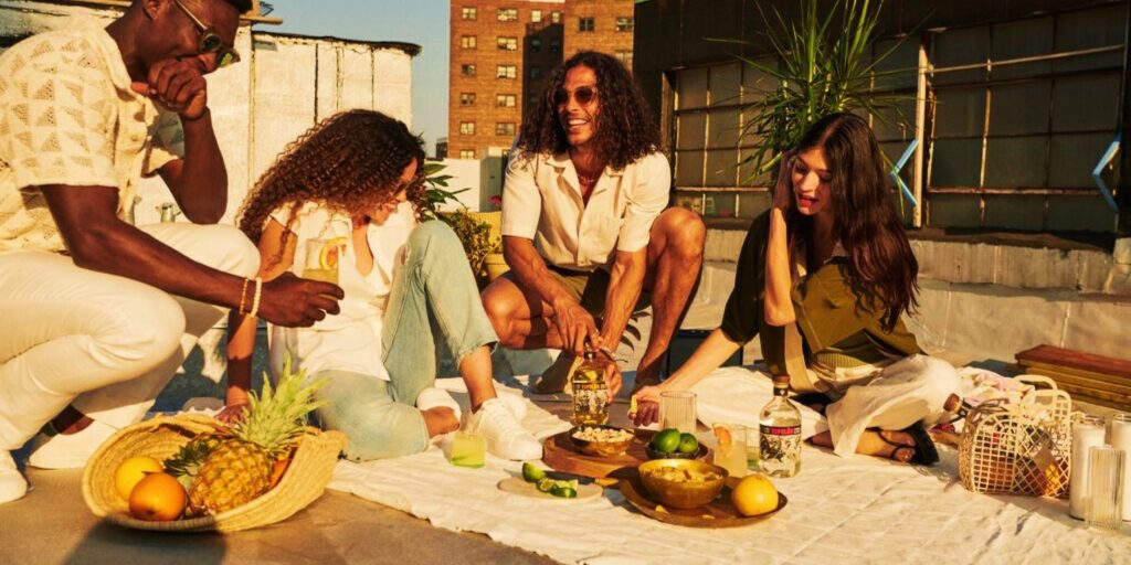 Friends enjoying Espolòn Tequila cocktails at a rooftop party