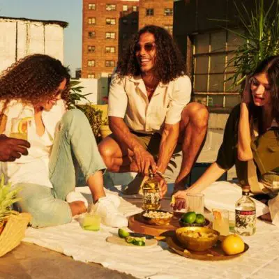 Friends enjoying Espolòn Tequila cocktails at a rooftop party