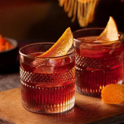 Close-up of two Montelobos Mezcal Negroni cocktails with orange peel garnish