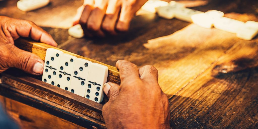 Close-up of hands playing dominoes in Cuba