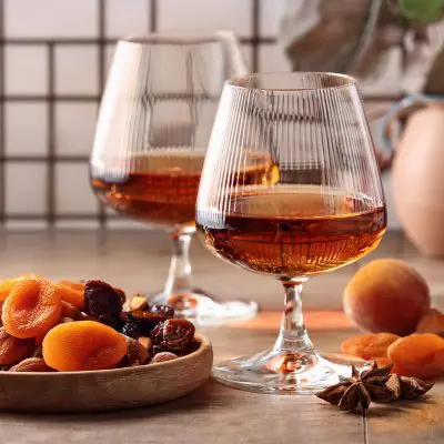 Two glasses of Cognac served with dried fruit