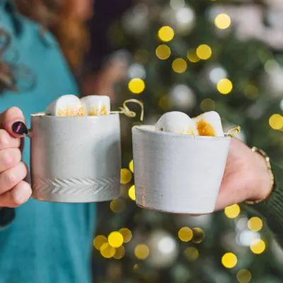 Friends clinking together mugs of Mexican Hot Chocolate