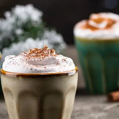 3 Christmassy Tom and Jerry cocktails in mugs