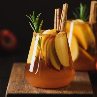 Apple Butter Old Fashioned in tumbler with apple slices and cinnamon sticks