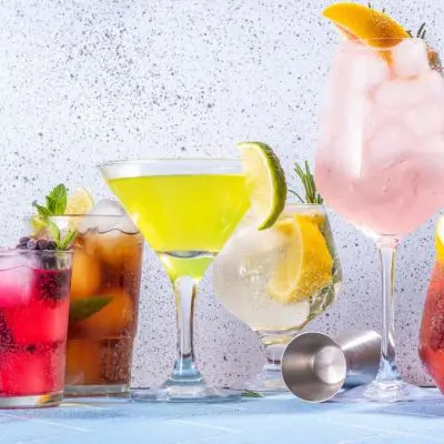 Multi-colored mocktails lined up in different glasses