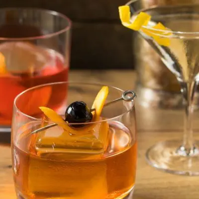 Front shot of five different cocktails on wooden table