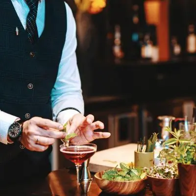 Japanese Bartender garnishing a cocktail