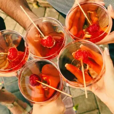 Top shot of friends toasting with strawberry Champagne cocktails