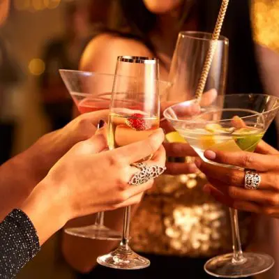 Women clinking cocktails together