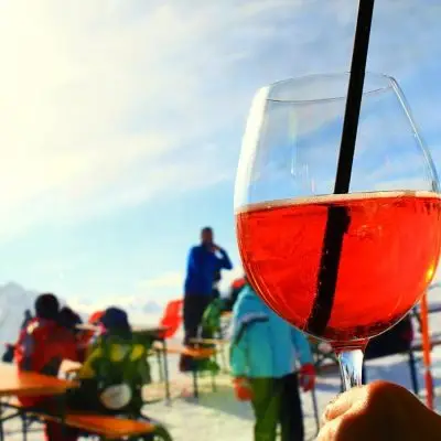 Aperol cocktail with ski slopes in the background