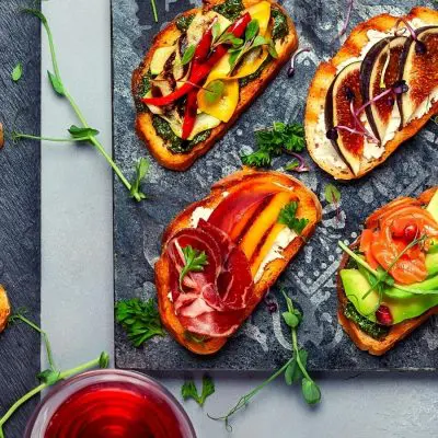 Top view of colorful Bruschetta appetizer with wine