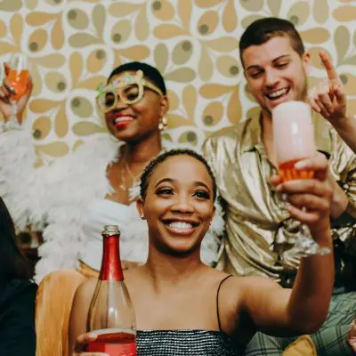 Friends posing for a photo holding their drinks