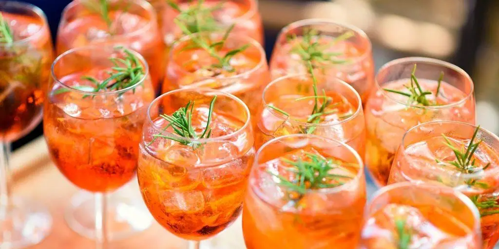 Top view of Aperol cocktails with rosemary garnish